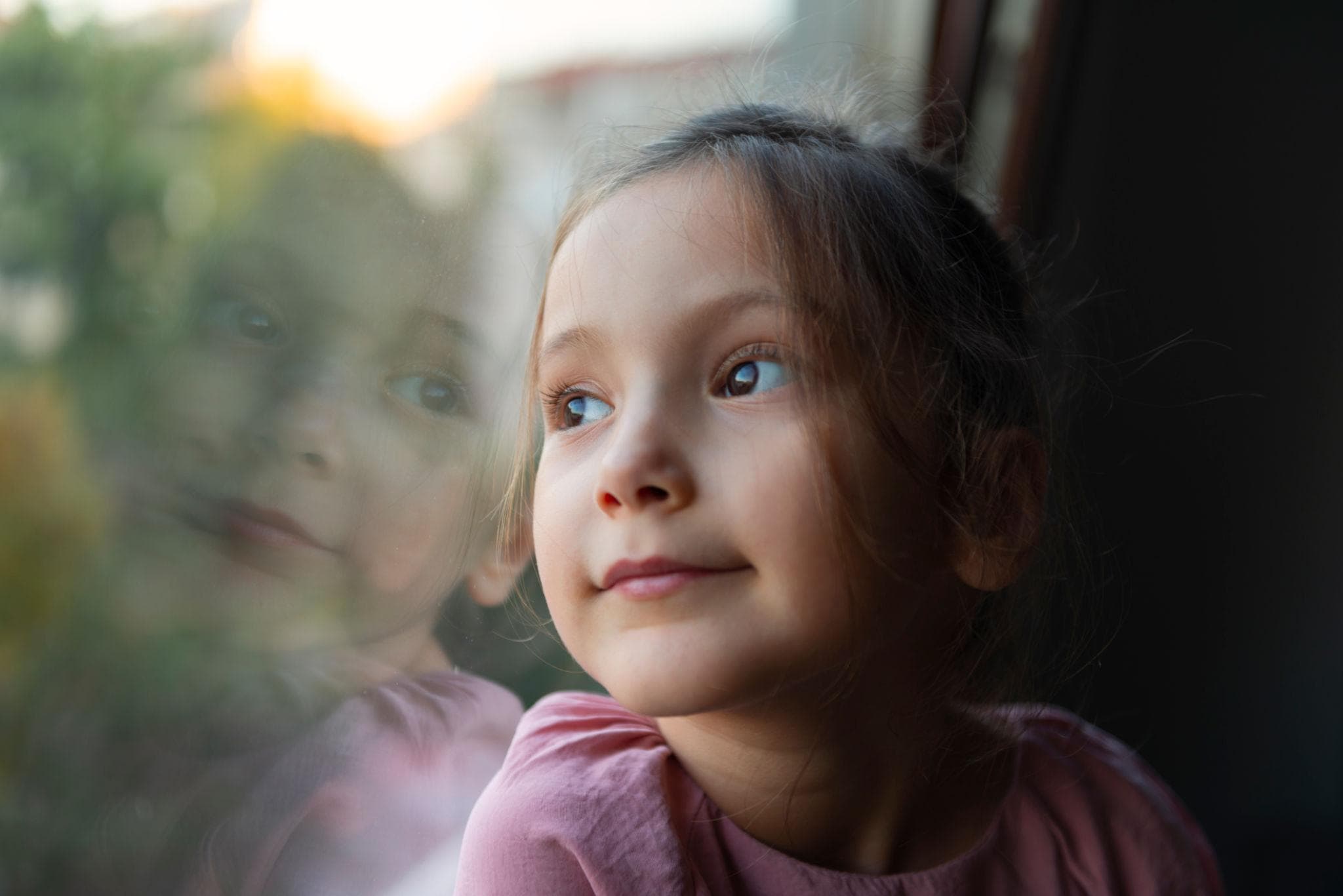 Child looking through window